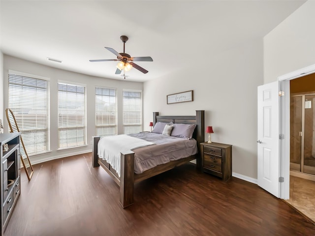 bedroom featuring dark wood-style floors, baseboards, visible vents, and a ceiling fan