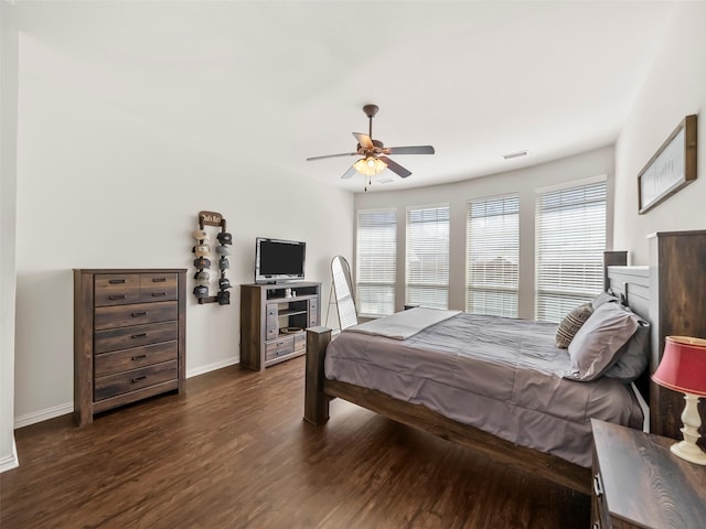 bedroom featuring visible vents, ceiling fan, baseboards, and wood finished floors