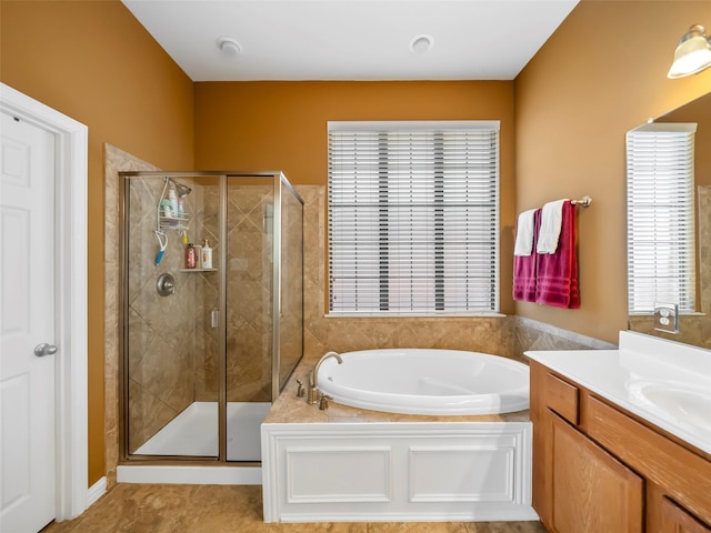 full bathroom featuring a garden tub, a shower stall, and vanity