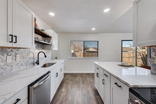 kitchen with a sink, light stone countertops, open shelves, and stainless steel dishwasher