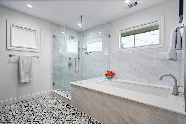 full bathroom with recessed lighting, visible vents, baseboards, a bath, and a stall shower