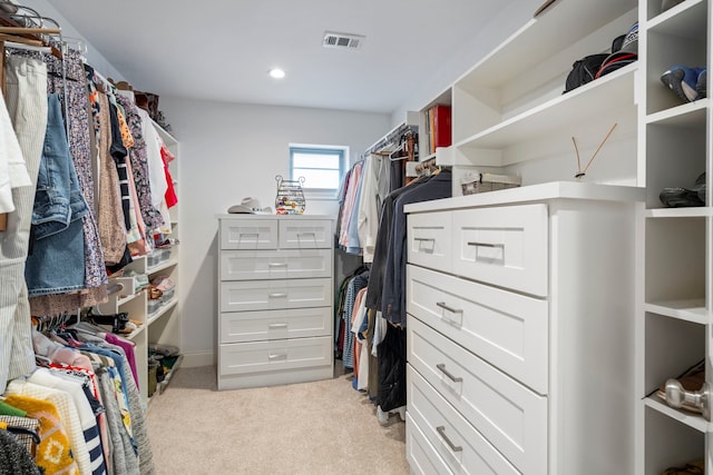 walk in closet with light colored carpet and visible vents