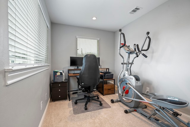 carpeted office featuring visible vents and baseboards