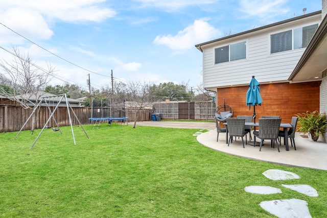 view of yard featuring a patio area, a fenced backyard, and a trampoline