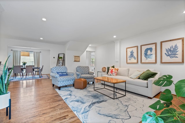 living room with baseboards, wood finished floors, and recessed lighting