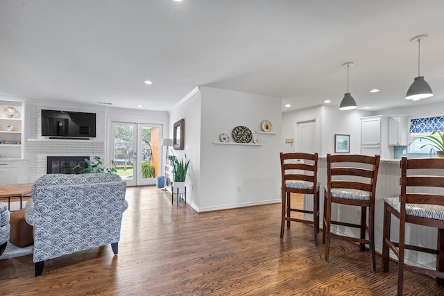 interior space with dark wood-style floors, plenty of natural light, and a fireplace