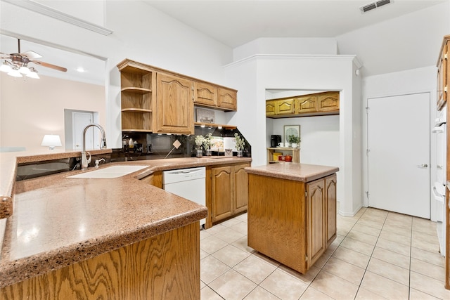 kitchen featuring open shelves, visible vents, light tile patterned flooring, a sink, and dishwasher