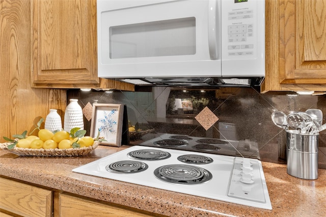 kitchen featuring white appliances and backsplash