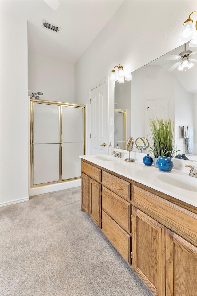 bathroom featuring carpet floors, double vanity, visible vents, a sink, and a shower stall