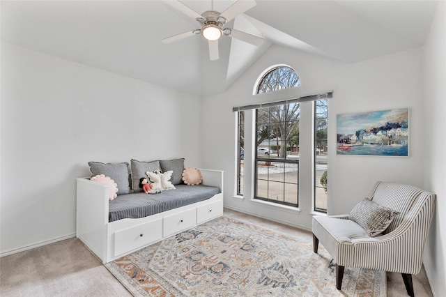 sitting room with carpet floors, vaulted ceiling, and ceiling fan