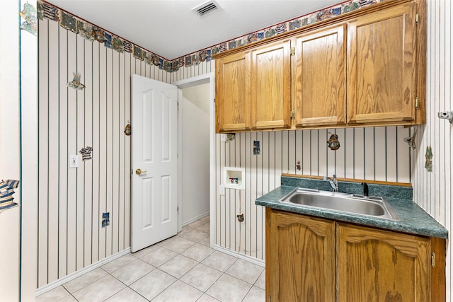 interior space featuring dark countertops, visible vents, a sink, and light tile patterned floors