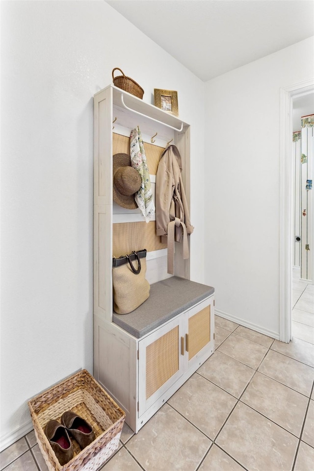 mudroom featuring light tile patterned flooring and baseboards