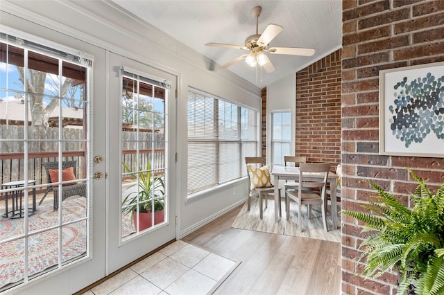 sunroom / solarium with ceiling fan and vaulted ceiling