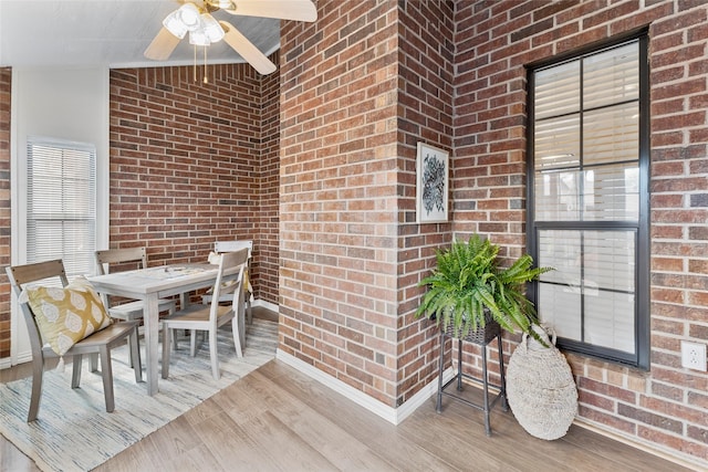 wooden terrace with ceiling fan and outdoor dining space