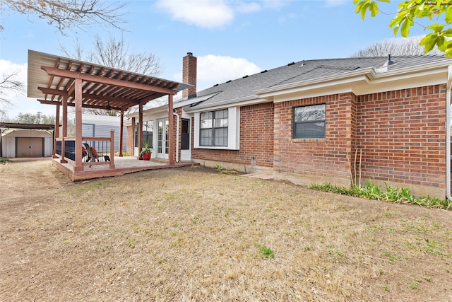 view of yard with a shed, a pergola, and an outbuilding