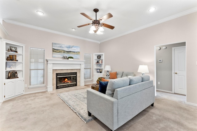 living area featuring a fireplace, baseboards, crown molding, and light colored carpet