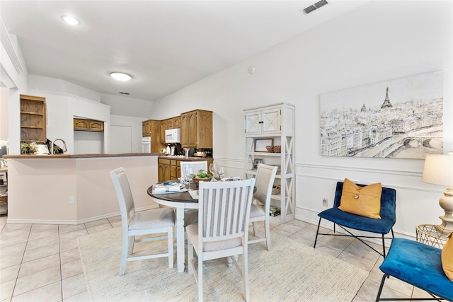 dining space featuring light tile patterned floors and visible vents