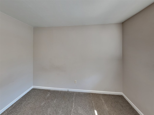 unfurnished room with carpet floors and baseboards
