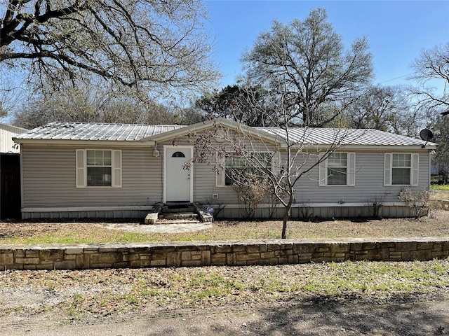 manufactured / mobile home featuring entry steps and metal roof