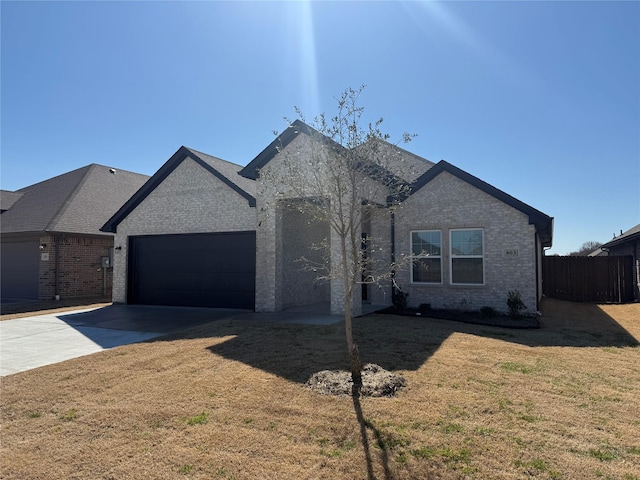 view of front of property featuring a garage, brick siding, fence, concrete driveway, and a front yard