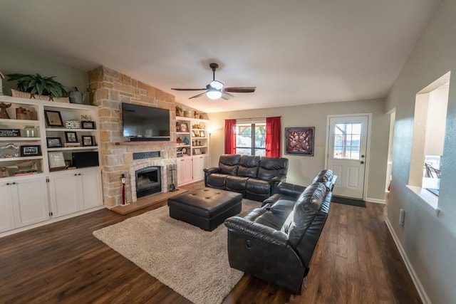 living room with dark wood-style flooring, a fireplace, lofted ceiling, ceiling fan, and baseboards