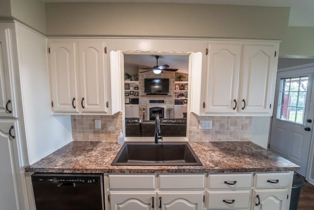 kitchen featuring dishwasher, decorative backsplash, a sink, and white cabinets