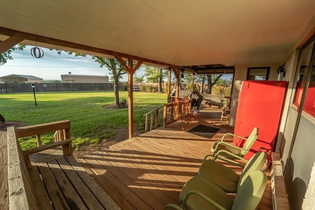 wooden deck featuring a lawn and fence