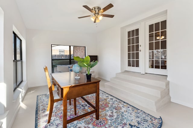 home office featuring a ceiling fan and baseboards