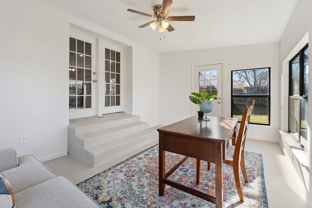 home office with baseboards, a ceiling fan, and a healthy amount of sunlight