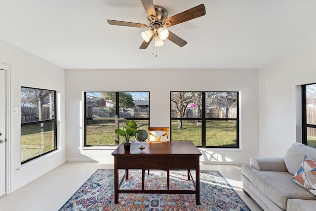 home office featuring a ceiling fan and baseboards