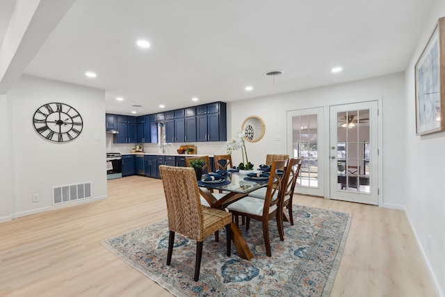 dining room featuring light wood finished floors, visible vents, and recessed lighting