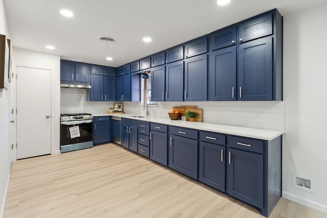 kitchen with blue cabinetry, light countertops, visible vents, appliances with stainless steel finishes, and under cabinet range hood