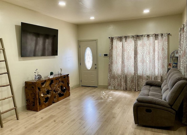 foyer with hardwood / wood-style flooring, baseboards, and recessed lighting