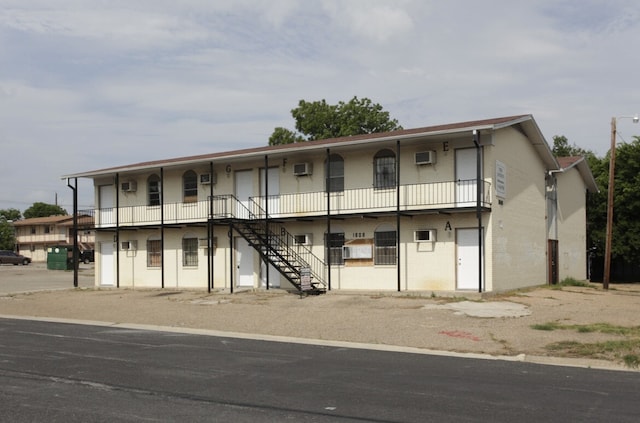 view of front of home with stairs and brick siding