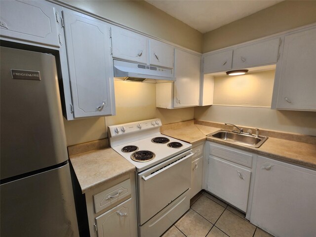 kitchen with white range with electric stovetop, freestanding refrigerator, white cabinetry, a sink, and under cabinet range hood