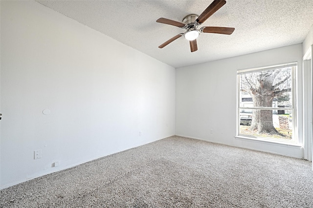 carpeted empty room with ceiling fan and a textured ceiling