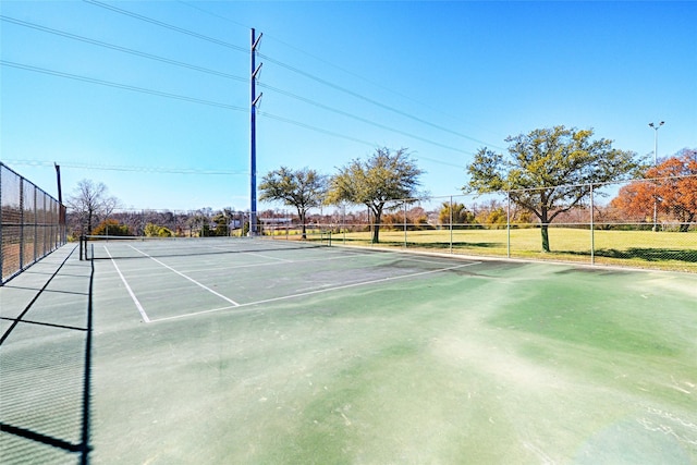 view of tennis court featuring fence