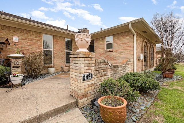 view of property exterior with brick siding