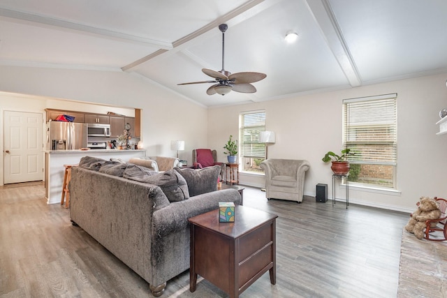 living area featuring vaulted ceiling with beams, ceiling fan, light wood-style flooring, and baseboards