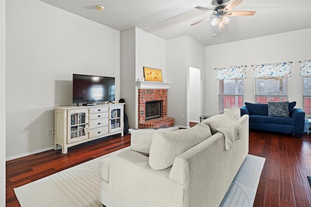 living room featuring baseboards, a fireplace, a ceiling fan, and wood finished floors