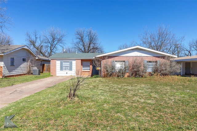 view of front of house featuring driveway, brick siding, a front lawn, and central air condition unit