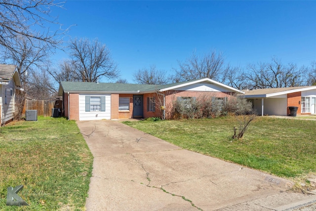 ranch-style house featuring fence, a front lawn, central AC, and brick siding