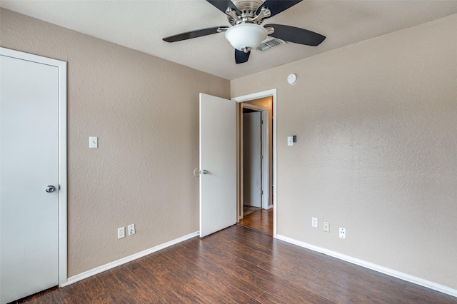 unfurnished bedroom with baseboards, visible vents, a textured wall, ceiling fan, and wood finished floors