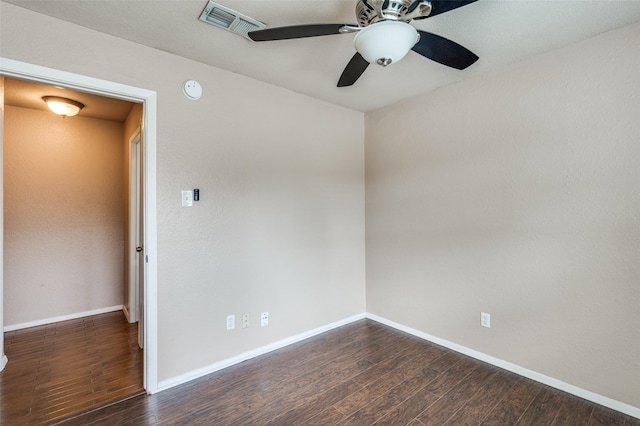 spare room featuring a ceiling fan, wood finished floors, visible vents, and baseboards