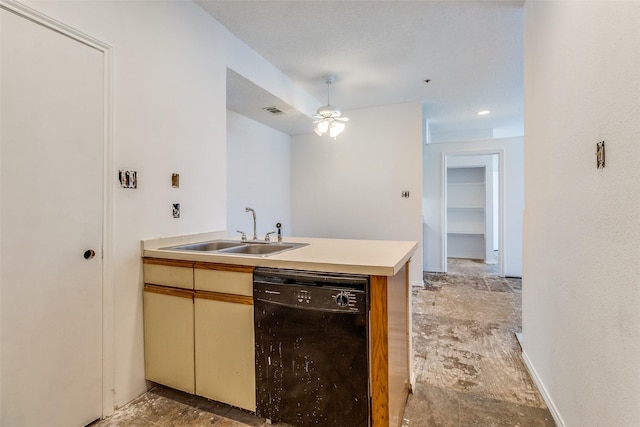 kitchen featuring a peninsula, a sink, a ceiling fan, light countertops, and dishwasher