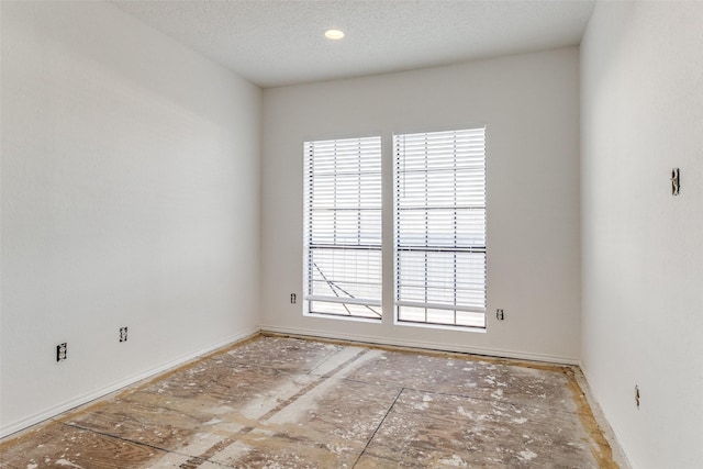 empty room featuring a textured ceiling