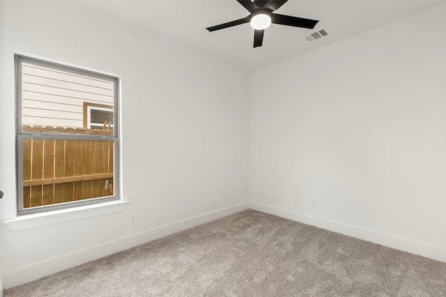 unfurnished room featuring carpet, visible vents, and baseboards