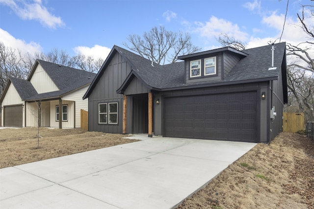 modern farmhouse featuring a garage, a shingled roof, fence, driveway, and board and batten siding