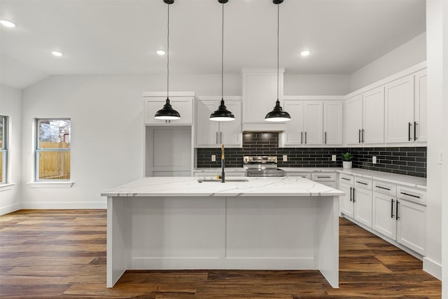 kitchen with dark wood-style flooring, a sink, an island with sink, and stainless steel electric stove