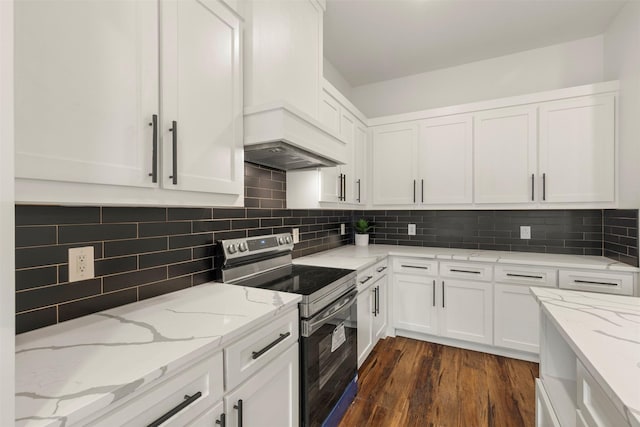 kitchen with stainless steel electric range oven, backsplash, and white cabinets